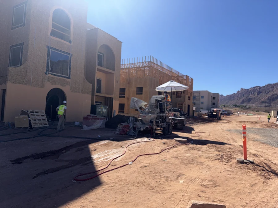 Construction photograph showing an arched entry and framing on the adjoining part of the site.